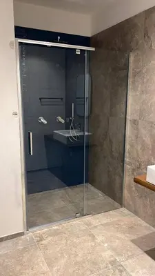 a glass shower in a bathroom with a sink at Villa della Pigna in Scopello