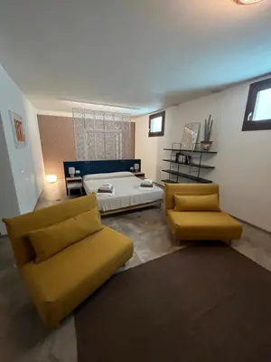 a living room with a bed and a couch at Villa della Pigna in Scopello