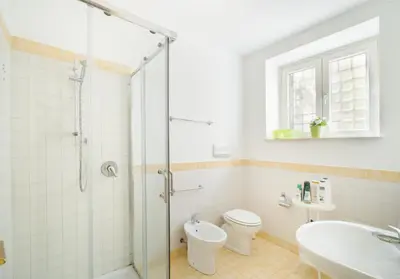a bathroom with a shower and a toilet and a sink at Casa Linda in Palermo