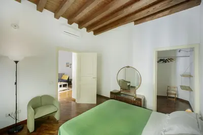 a bedroom with a green bed and a chair at Casa Linda in Palermo