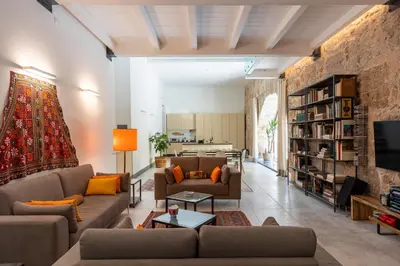 a living room with two couches and a tv at Valverde Art Space Loft by DomuSicily in Palermo
