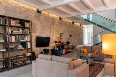 a living room with two couches and a brick wall at Valverde Art Space Loft by DomuSicily in Palermo