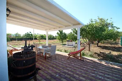 a patio with a white canopy and a table and chairs at casa tre noci in Lascari
