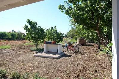a bike parked next to a table in a field at casa tre noci in Lascari