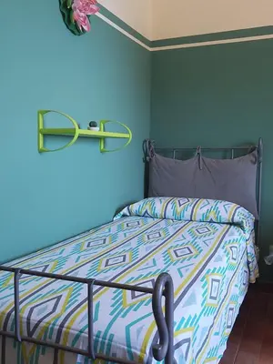 a bedroom with a bed with a blue wall at Casa Igiea in Palermo