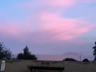 a sky with a bench in front of a wall at Casa Igiea in Palermo