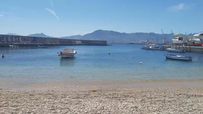 a group of boats in the water near a beach at Casa Igiea in Palermo