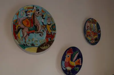 three plates are hanging on a wall at Guisomar in Palermo