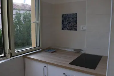 a kitchen with a window and a wooden counter top at Guisomar in Palermo