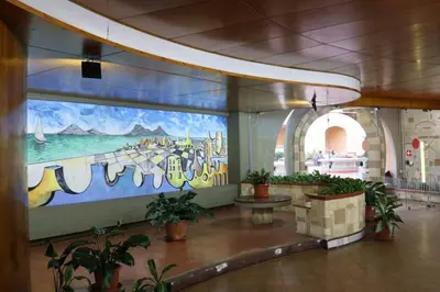 a large mural on the wall of a building with plants at Guisomar in Palermo