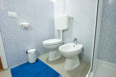 a bathroom with a toilet and a sink and a shower at Casa MaMo 36 in Palermo
