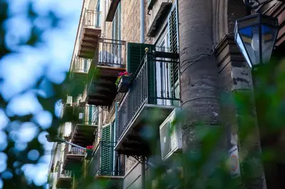 an apartment building with balconies and a street light at Casa MaMo 36 in Palermo