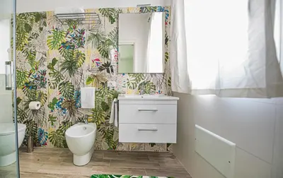 a bathroom with a toilet sink and a mirror at L' Arcobaleno B&B in Castelluzzo
