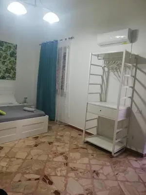 a bedroom with a bed and a book shelf at NONNA MARIA Apt 1 or Apt 2 in Terrasini