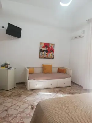 a white couch in a room with a tv at NONNA MARIA Apt 1 or Apt 2 in Terrasini