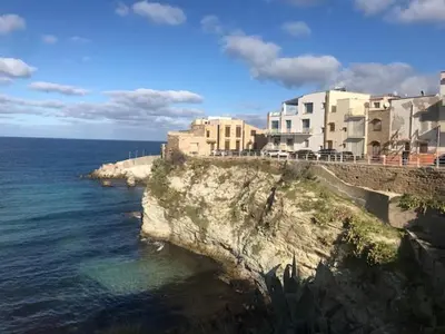 a building on top of a cliff next to the ocean at NONNA MARIA Apt 1 or Apt 2 in Terrasini