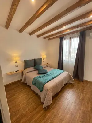 a bedroom with a bed in a room with wooden floors at Interno12 in Palermo