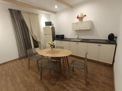 a kitchen with a table and chairs in a room at Interno12 in Palermo