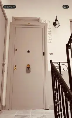 a white door with a clock on the wall at Interno12 in Palermo