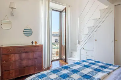 a bedroom with a bed and a dresser and a window at Terrazza al Capo by Wonderful Italy in Palermo