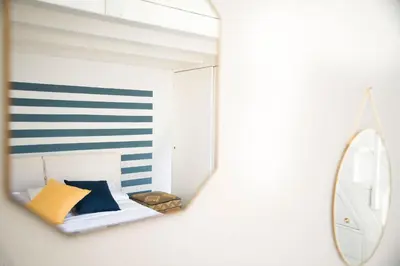 a mirror reflection of a bed in a room at Terrazza al Capo by Wonderful Italy in Palermo