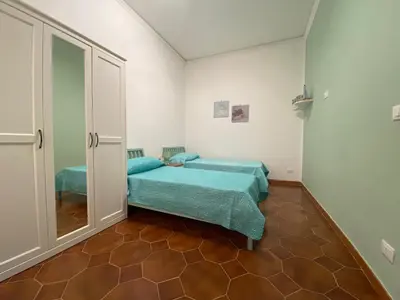 a bedroom with a bed and a mirror at La Casetta di Nonna Anna in Palermo
