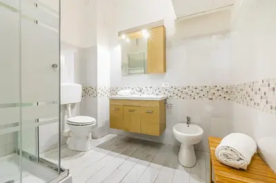a bathroom with a toilet and a sink and a shower at GuestHost - Corso dei Mille Railway Apartment in Palermo