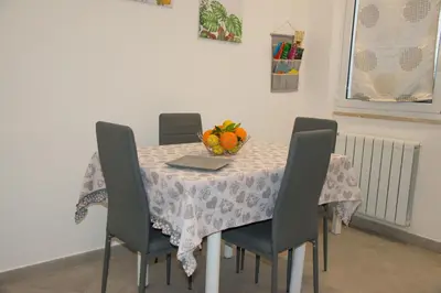 a dining room table with a bowl of fruit on it at MONDELLO MANICK MARE in Palermo
