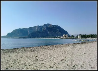 a view of a beach with a mountain in the background at MONDELLO MANICK MARE in Palermo