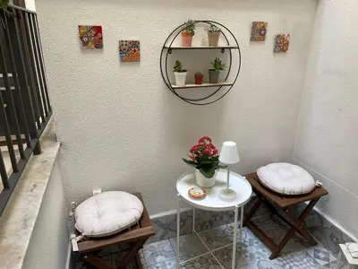 a room with two chairs and a table and a mirror at Amalfitani House in Palermo