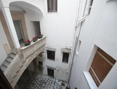 an internal view of a building with flowers on a balcony at Amalfitani House in Palermo