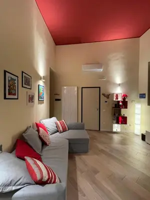 a living room with two couches and a red ceiling at Amalfitani House in Palermo