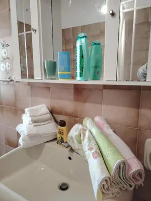 a bathroom with a sink and towels on a tub at CASA Spezie 1PD Climatizzata in Castellammare del Golfo