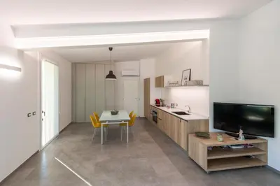 a living room with a table and a television at Villa Cappèddu in Balestrate