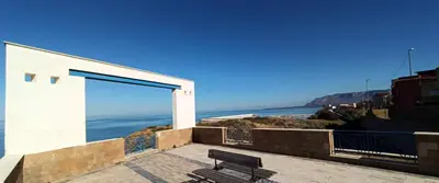 a bench sitting on a balcony looking at the ocean at Villa Cappèddu in Balestrate