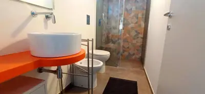 a bathroom with a sink and a shower and a toilet at Villa Cappèddu in Balestrate