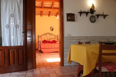 a dining room with a table with a yellow table cloth at Baglio Cracchiolo Casa Baldo in San Vito lo Capo
