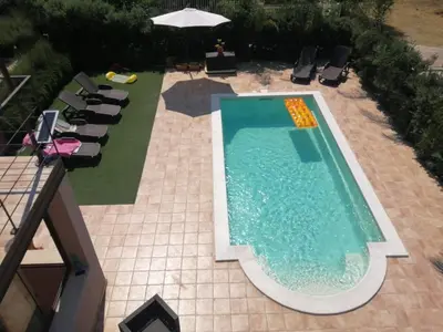 an overhead view of a swimming pool with chairs and an umbrella at Villa Giorgia 2020 in Cefalù
