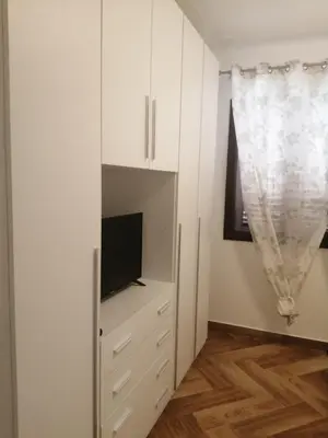 a white cabinet with a television and a curtain at Villa Giorgia 2020 in Cefalù