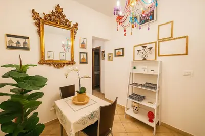 a dining room with a table and a mirror at Briogna by Maravigghia Palermo in Palermo