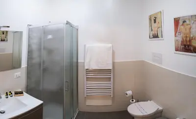 a bathroom with a shower and a toilet and a sink at Briogna by Maravigghia Palermo in Palermo