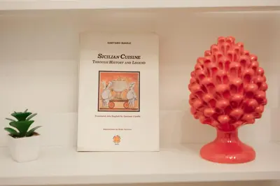 a book and a red balloon on a shelf next to a plant at Briogna by Maravigghia Palermo in Palermo