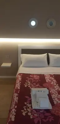 a bedroom with a bed with towels on it at Dietro il massimo in Palermo