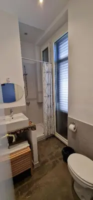 a bathroom with a toilet and a sink and a shower at Palermo Rooms in Palermo
