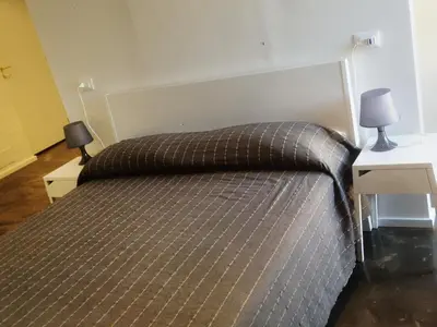 a bed in a room with two tables and two lamps at Palermo Rooms in Palermo