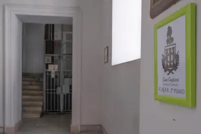 a hallway with a green sign on a wall at Casa Gagliani, a Liberty house in the old downtown in Palermo
