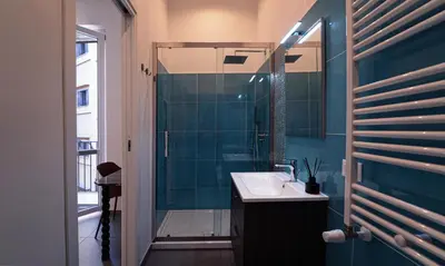 a bathroom with a sink and a shower at Zefiro Suites in Palermo