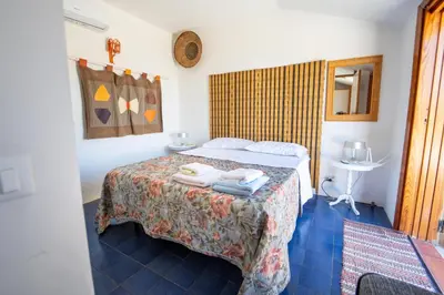 a bedroom with a bed with towels on it at Villa Claudia in Scopello