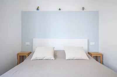 a bedroom with a white bed with two pillows at B&B Babbaluci - Centro Storico in Palermo