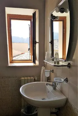 a bathroom with a sink and a window at Agriturismo Masseria La Chiusa in San Giuseppe Jato